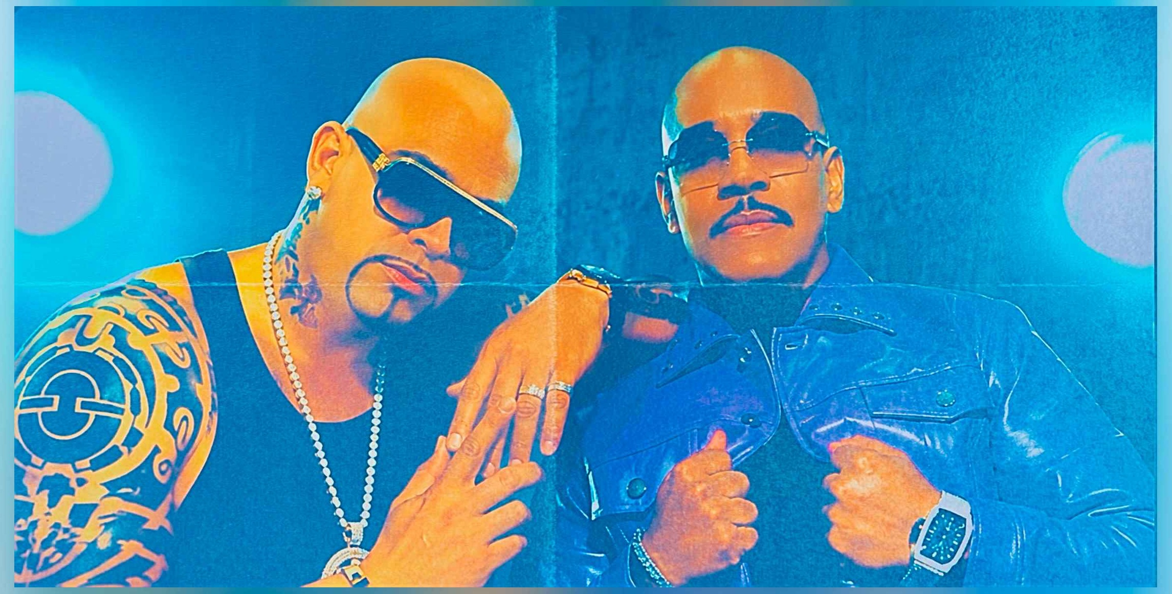 Two music creators posing under stage lights
